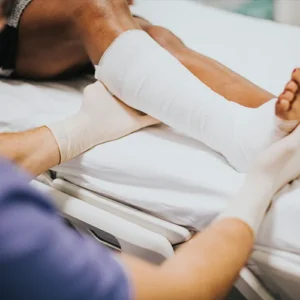 Doctor examines patient with leg injury.