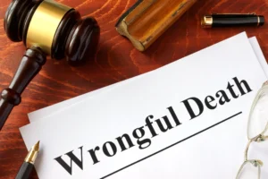 A wrongful death claim document and a wooden gavel resting on a desk.