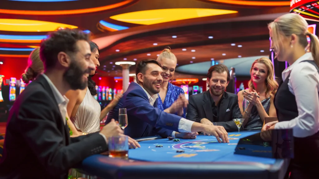 A group of people around a casino table.