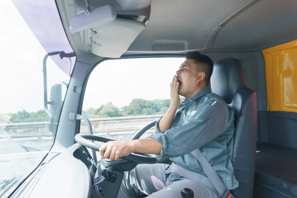 A driver, yawning while driving.